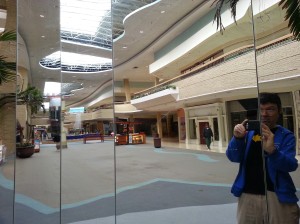 Blog author reflected in empty mall mirrors