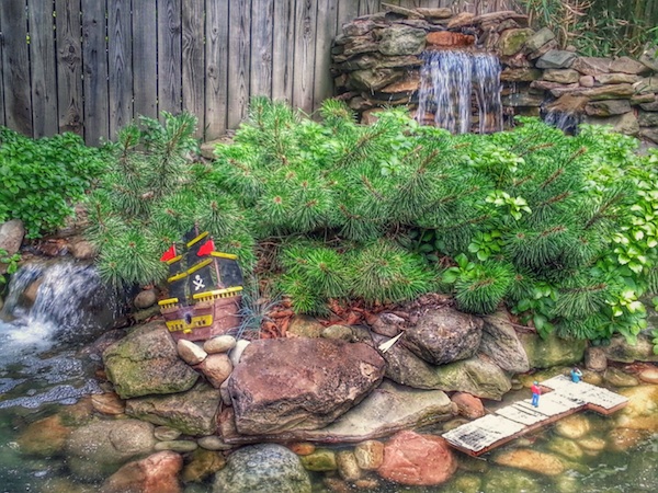 garden with waterfalls and model pirate ship and dock