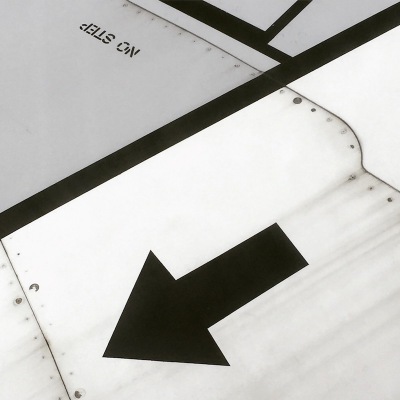 detail of arrow painted on the wing of an airplane