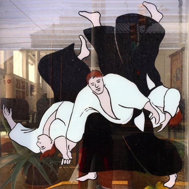 window glass mural of man throwing two others in martial arts combat, Etna, PA