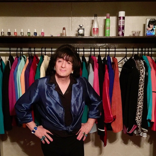 Billie Nardozzi in front of a closet full of colorful women's blazers