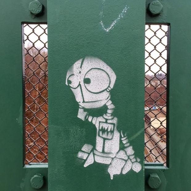 stencil image of cartoon robot painted on bridge, Pittsburgh, PA