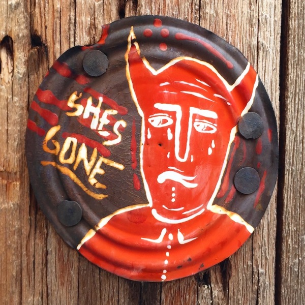 tin can lid painted with sad devil and the words "She's gone", Pittsburgh, PA