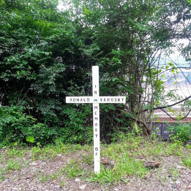 wooden memorial cross by bicycle trail