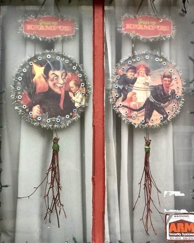 Krampus holiday decorations in row house window, Pittsburgh, PA