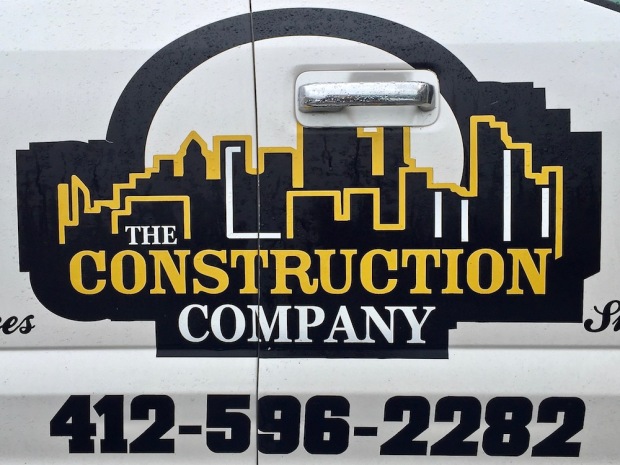 logo for The Construction Company featuring artistic rendering of Pittsburgh skyline in black and gold