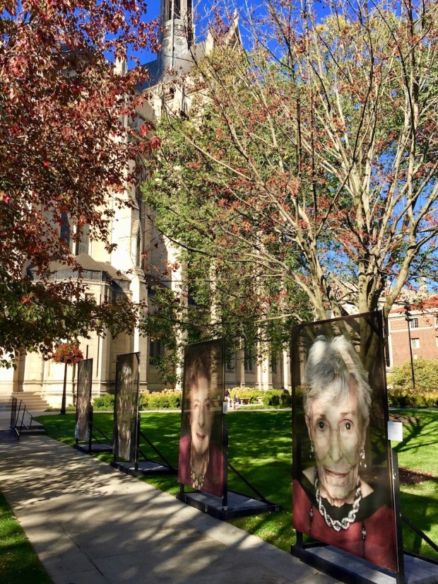large portraits of Holocaust survivor mounted on exterior display at the University of Pittsburgh campus as part of Luigi Toscano's "Lest We Forget" portrait series