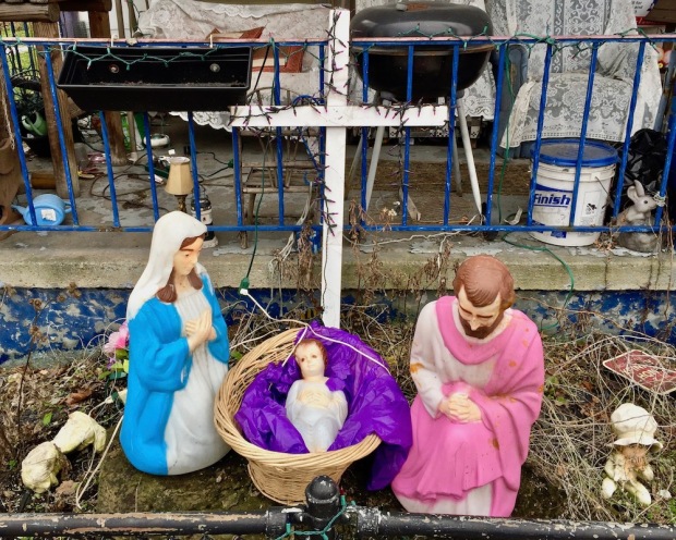 Christmas nativity scene with plastic Mary, Joseph, and baby Jesus decorations outside home