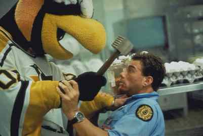 still from film "Sudden Death" of Jean-Claude Van Damme fighting with Iceburgh, the Pittsburgh Penguins mascot