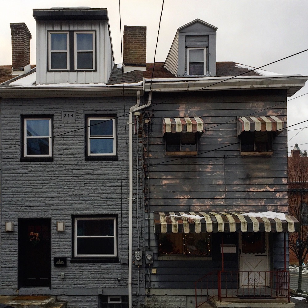 pair of row houses, both painted gray