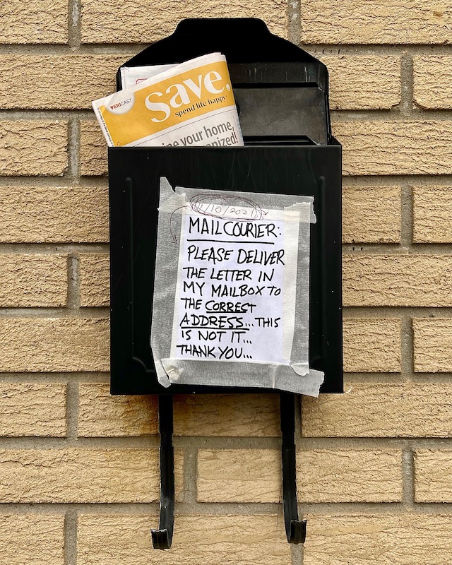 instructions for mail carrier written on paper taped to mailbox