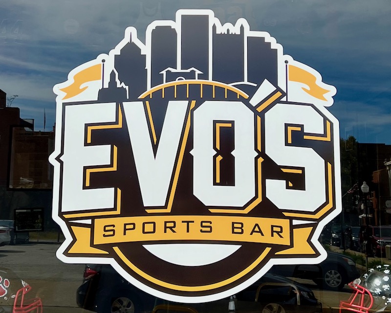 window decal for Evo's Sports Bar featuring silhouette of downtown Pittsburgh