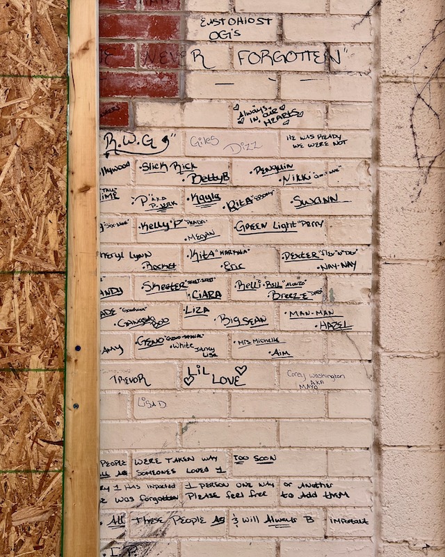 brick wall with names of deceased community members