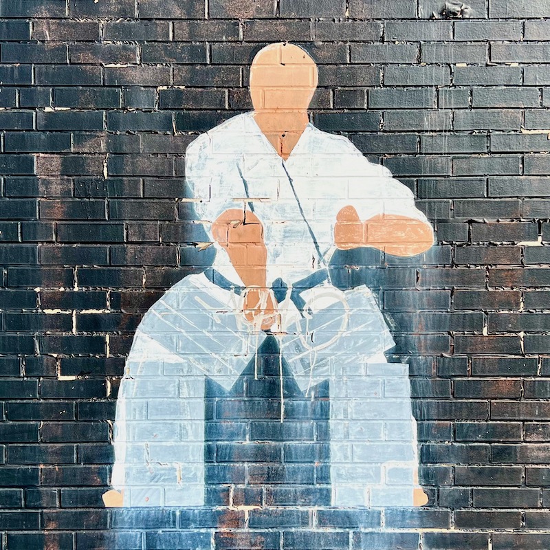 mural of figure in martial arts gown breaking cinder blocks