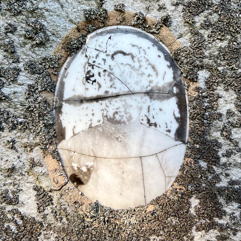 ceramic photo grave marker inset with person's head no longer recognizable