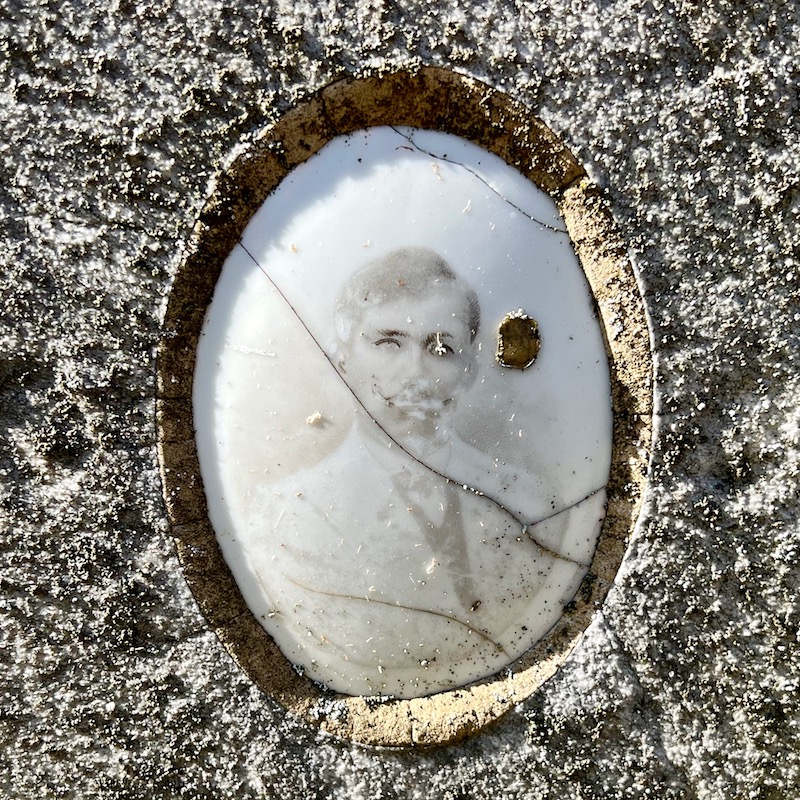 ceramic photo grave marker inset of photo so faded as to appear ghostly