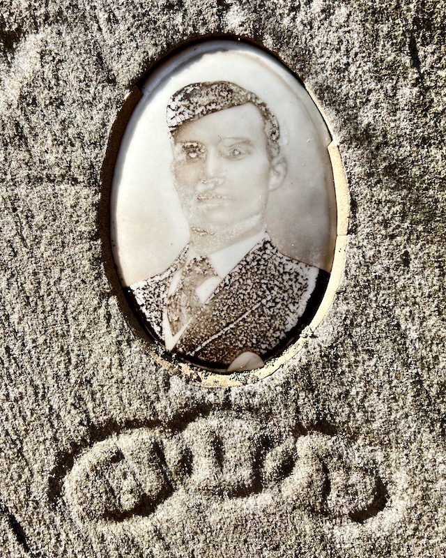 ceramic photo grave marker inset of young man disintegrating