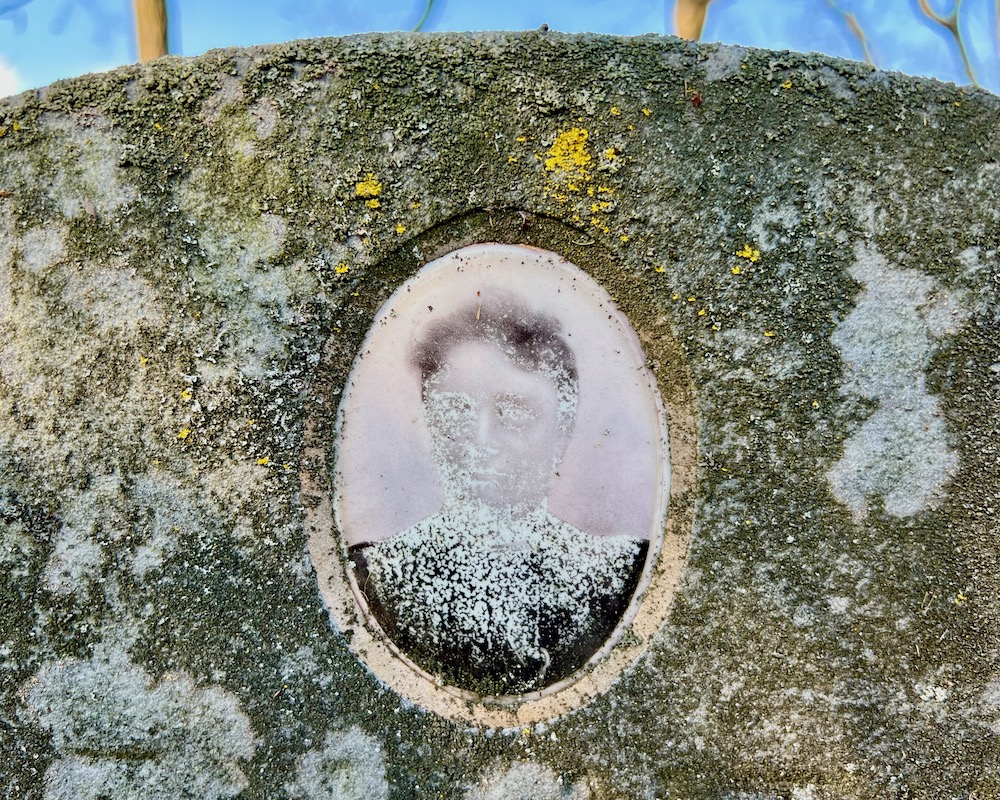 ceramic photo grave marker inset of woman with head disintegrating