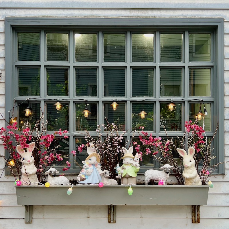 window with flower box filled with Easter bunnies