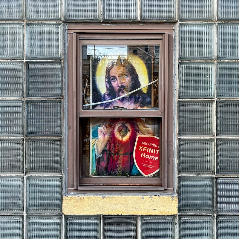 window inset to glass block wall with image of Jesus