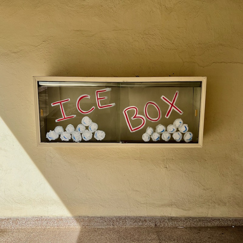 retail display box windows painted over with words "Ice Box"