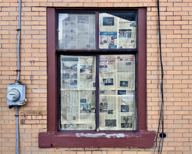 window with newspaper covering glass