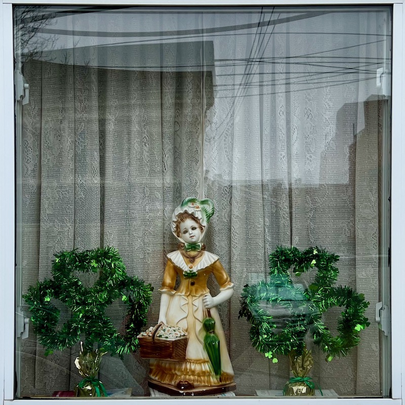 rowhouse window decorated for St. Patrick's Day