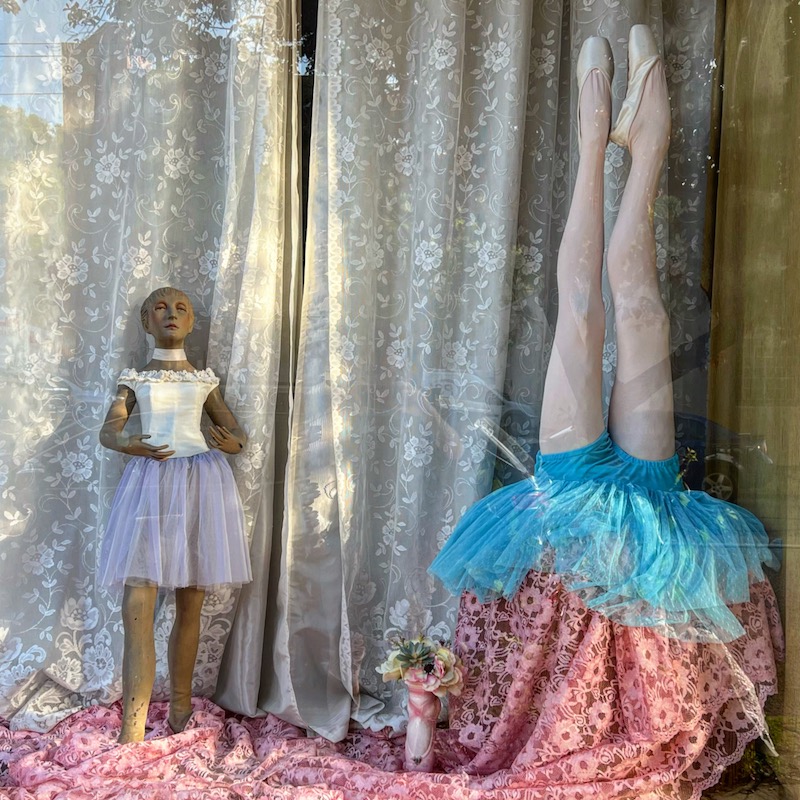 retail storefront window with mannequins in ballet dance wear