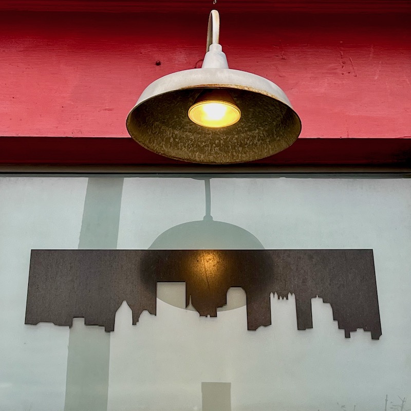 bar window decorated with silhouette of downtown Pittsburgh skyline