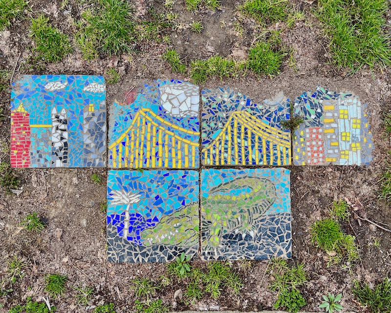 mosaic tiles depicting downtown Pittsburgh and an alligator