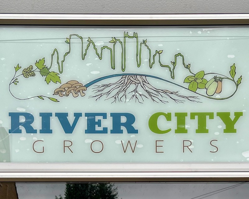 business sign with skyline of downtown Pittsburgh appearing grown from plants