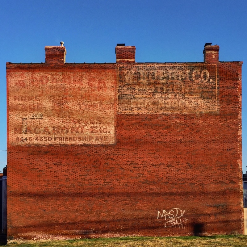 brick wall painted with faded advertisement for W. Boehm Co.