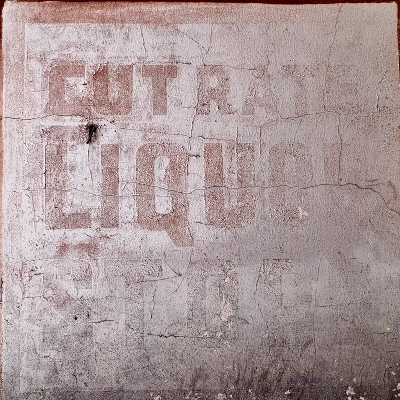 faded ghost sign for long-gone liquor store