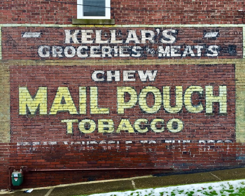 brick wall painted with faded advertisement for Mail Pouch tobacco