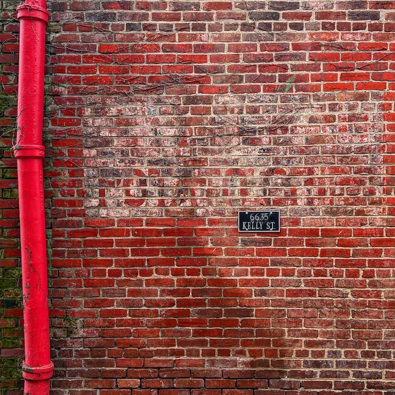 brick wall painted with faded advertisement for potato chips