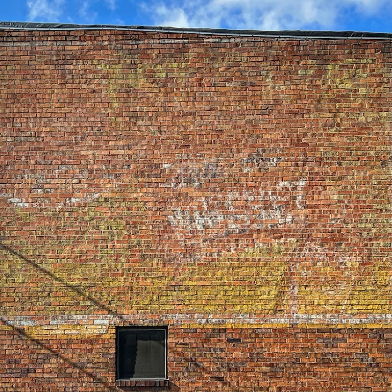brick wall painted with very whiskey advertisement