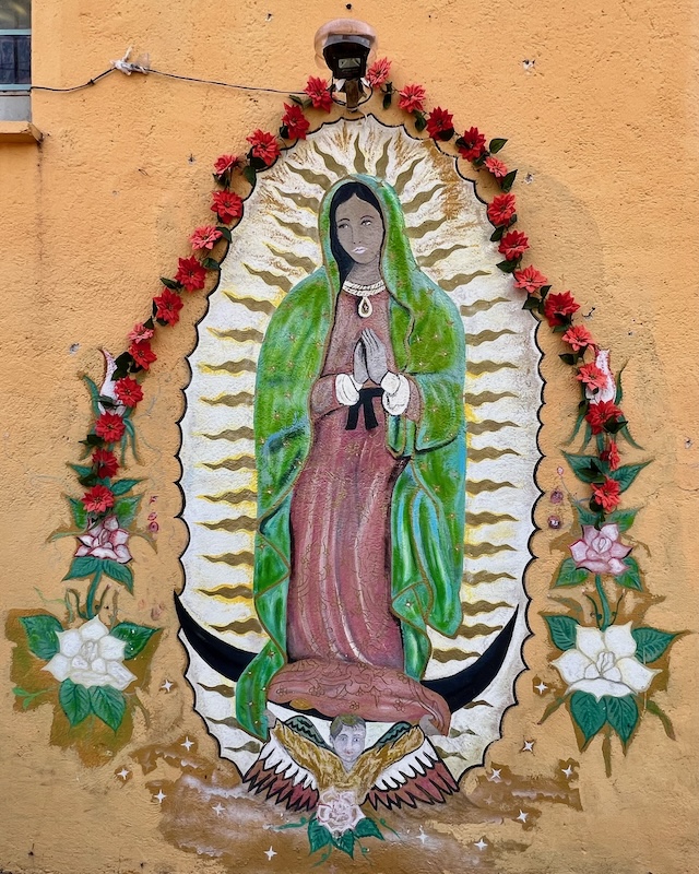 mural of Virgin Mary of Guadalupe painted on exterior house wall