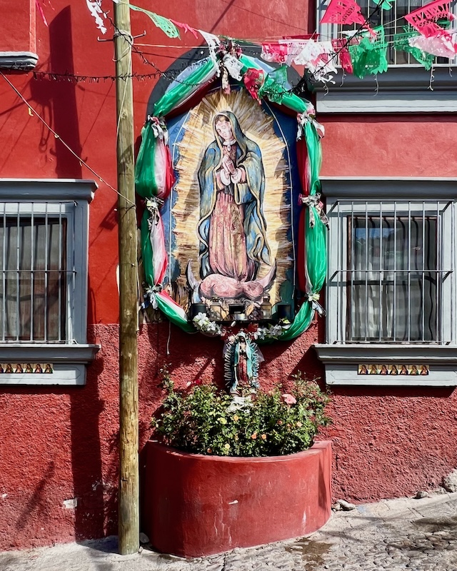 mural of Virgin Mary of Guadalupe painted on exterior house wall